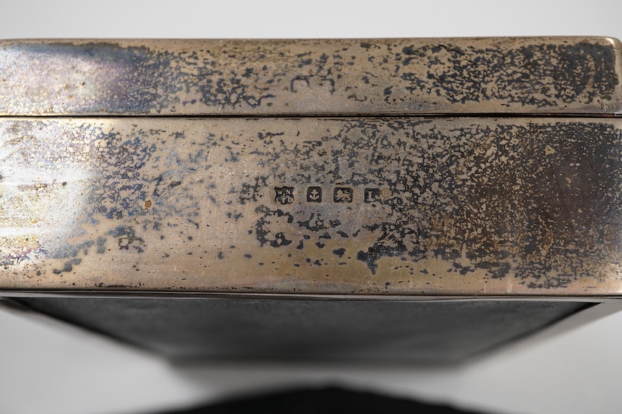 A George V engine turned silver mounted rectangular cigarette box, by William Neale Ltd, Birmingham, 1935, 16.2cm.